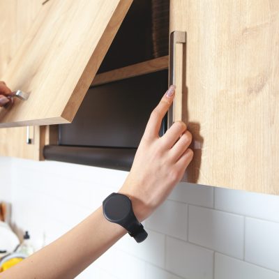 Caucasian,Woman,Opens,The,Kitchen,Door,Furniture.