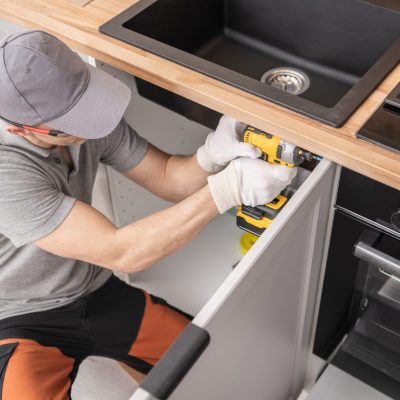 Caucasian,Professional,Cabinetmaker,In,His,40s,Assembling,Kitchen,Cabinets,Furniture