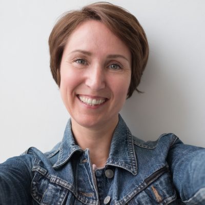 Portrait,Of,A,Middle-aged,Woman,In,A,Denim,Jacket.,She